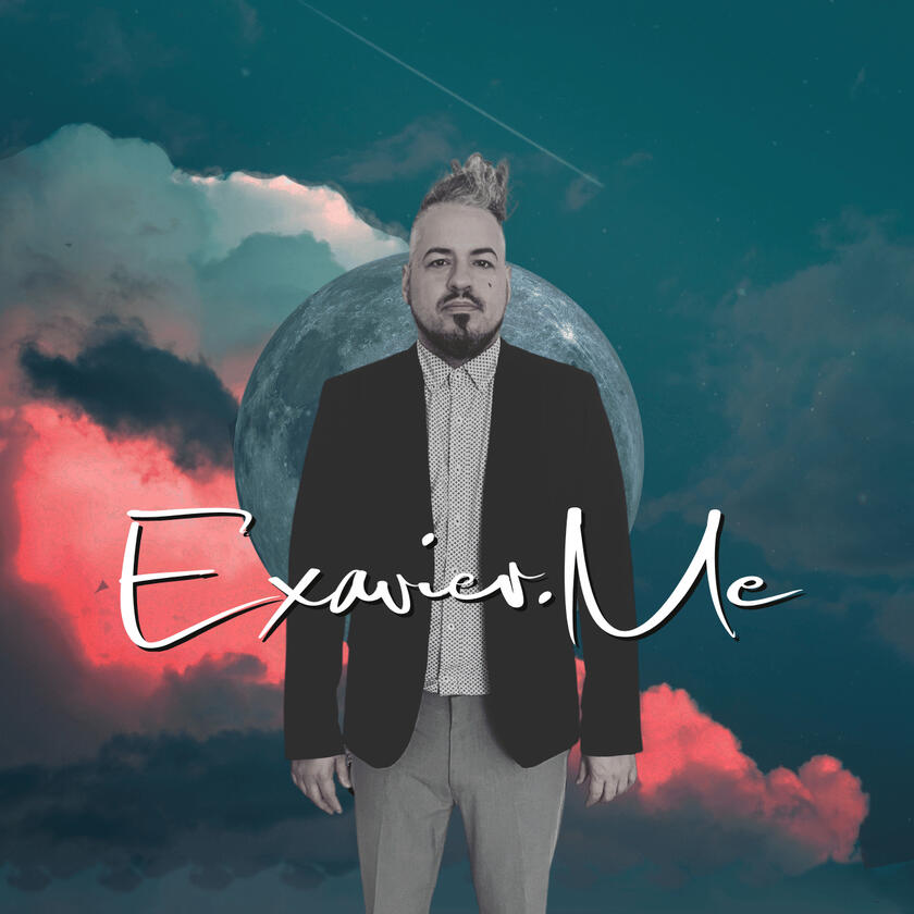 Exavier.Me Gallery Image 2 Exavier Me standing in front of a planet, in front of clouds, he wears a fulled button shirt with a blazer and disheveled hair standing and leaning to the side.